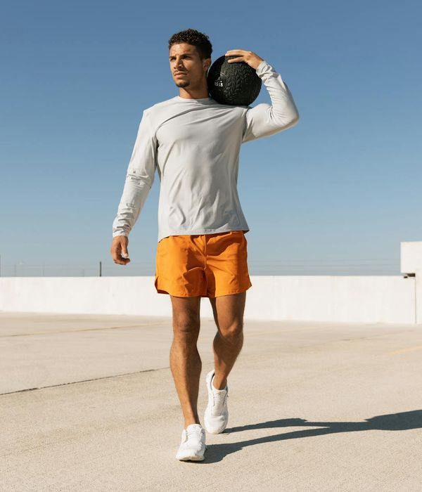 Man performing a strength exercise in a modern gym environment.